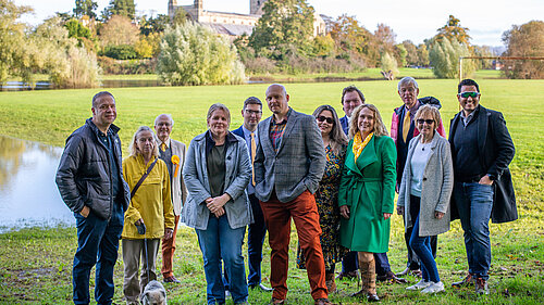 Tewkesbury Liberal Democrats stand in front of Tewkesbury Abbey